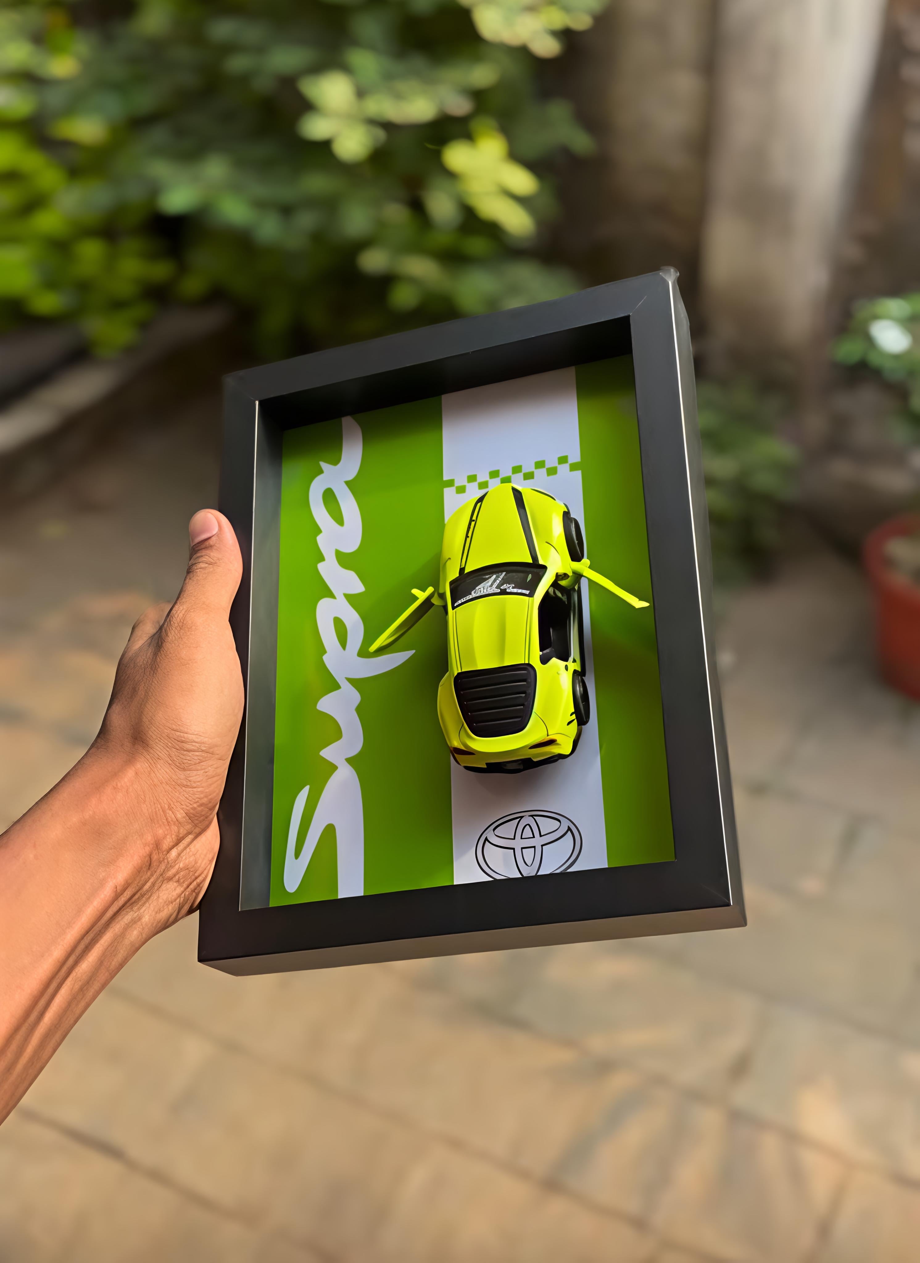 Toyota Supra neon yellow die-cast model in black shadow box display frame